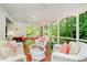 Screened porch features seating and views to the treed back yard at 6280 N Chester Ave, Indianapolis, IN 46220