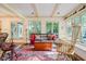 Sun-filled room with wooden furniture and large windows providing beautiful views of the outdoors at 6280 N Chester Ave, Indianapolis, IN 46220