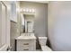 This is a bathroom with a white marble vanity and a toilet with gray colored walls at 629 E 25Th St, Indianapolis, IN 46205