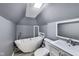 Bathroom with freestanding tub, gray walls, sloped ceiling and a skylight above at 629 E 25Th St, Indianapolis, IN 46205