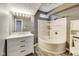 Bathroom featuring tub shower combination, vanity and toilet with gray colored walls at 629 E 25Th St, Indianapolis, IN 46205