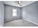 An empty bedroom featuring neutral carpet, a window, standard ceiling fan, and gray walls at 629 E 25Th St, Indianapolis, IN 46205