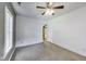 Bedroom features include neutral carpet and ceiling fan and a door leading to the bathroom at 629 E 25Th St, Indianapolis, IN 46205