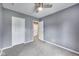 This bedroom contains neutral carpet, a standard ceiling fan and two doors for closets at 629 E 25Th St, Indianapolis, IN 46205