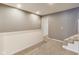 An upstairs hallway with carpeted floors with gray colored walls and white trim at 629 E 25Th St, Indianapolis, IN 46205