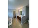 Bathroom with a double sink vanity, tile floors, and separate tub. Features a walk in closet through a door at 6632 Coppel Ct, Indianapolis, IN 46259