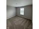 Clean and simple bedroom with carpet and window at 6632 Coppel Ct, Indianapolis, IN 46259