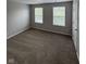 A spacious bedroom is well-lit by the two large windows at 6632 Coppel Ct, Indianapolis, IN 46259