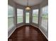 Bright breakfast nook with multiple windows, hardwood floor, and walk-out access at 6632 Coppel Ct, Indianapolis, IN 46259