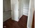 View of walk-in closet with carpeted bedroom and hardwood floor, wire shelving at 6632 Coppel Ct, Indianapolis, IN 46259