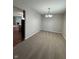 Neutral carpeted dining room with hardwood hallway to the kitchen and fireplace at 6632 Coppel Ct, Indianapolis, IN 46259