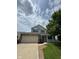 Charming two-story home with a brick and vinyl exterior, attached two-car garage and covered front porch at 6632 Coppel Ct, Indianapolis, IN 46259