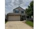 Charming two-story home with a brick and vinyl exterior, attached two-car garage and covered front porch at 6632 Coppel Ct, Indianapolis, IN 46259