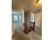 Second floor hallway with carpet and a wood banister in view of bedrooms and an entrance to the Primary suite at 6632 Coppel Ct, Indianapolis, IN 46259