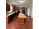 Kitchen with wood cabinets, mosaic backsplash, island, and black appliances at 6632 Coppel Ct, Indianapolis, IN 46259
