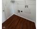 Laundry room with hardwood floors, white walls, trim and baseboards at 6632 Coppel Ct, Indianapolis, IN 46259