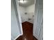 Laundry room with hardwood floors, white walls, trim and baseboards, and overhead shelving at 6632 Coppel Ct, Indianapolis, IN 46259