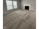 A large carpeted living room featuring a fireplace and backyard views at 6632 Coppel Ct, Indianapolis, IN 46259