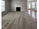 A large carpeted living room featuring a fireplace and views into the backyard and breakfast nook at 6632 Coppel Ct, Indianapolis, IN 46259