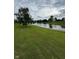 Scenic water view with a small pond, lush grass and mature trees offering tranquility at 6632 Coppel Ct, Indianapolis, IN 46259