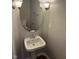 Charming powder room featuring a pedestal sink, mirror, and classic lighting at 6632 Coppel Ct, Indianapolis, IN 46259