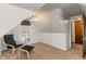 Finished attic space with stylish chair and ottoman, perfect as a reading nook or quiet getaway at 718 E Washington St, Lebanon, IN 46052