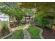 A beautiful backyard showcasing a stone path leading to a pergola-covered gate at 718 E Washington St, Lebanon, IN 46052