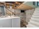 The basement features unfinished walls, a laundry area, and access to the upper floors at 718 E Washington St, Lebanon, IN 46052