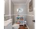 Compact bathroom offering a convenient toilet, sink, oval mirror, and a shelf with rolled towels and decor, creating a tidy space at 718 E Washington St, Lebanon, IN 46052