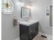 Stylish bathroom features a dark vanity, updated fixtures, and a bright octagon window at 718 E Washington St, Lebanon, IN 46052
