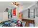 Bright bedroom featuring a ceiling fan, hardwood floors, and built-in shelving for storage and organization at 718 E Washington St, Lebanon, IN 46052