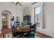 Elegant dining room with dark wood table, chairs, black and white rug, and a window, offering a perfect setting for meals at 718 E Washington St, Lebanon, IN 46052