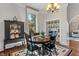 Charming dining room featuring a dark wood table, chairs, china cabinet, patterned rug, and a bright window for a delightful ambiance at 718 E Washington St, Lebanon, IN 46052
