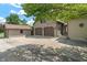 A home exterior featuring a two-car garage, spacious driveway, and a storage shed at 718 E Washington St, Lebanon, IN 46052