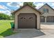 Exterior view of two-car garage with gabled roof and brown doors at 718 E Washington St, Lebanon, IN 46052