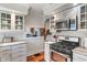 Modern kitchen featuring white cabinets, a marble countertop, stainless steel appliances, and an opening to the living room for easy access at 718 E Washington St, Lebanon, IN 46052