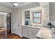 Bright kitchen with white cabinetry, stainless sink, marble countertops, subway tile backsplash, and hardwood floors for a modern touch at 718 E Washington St, Lebanon, IN 46052