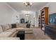 Spacious living room with plush sectional sofa, adjacent dining room, and a view of a bookcase in a beautifully styled home at 718 E Washington St, Lebanon, IN 46052