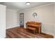 Bright living room featuring a piano, hardwood floors, ample space, and plenty of natural light, perfect for entertaining at 718 E Washington St, Lebanon, IN 46052
