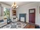Cozy living room featuring a decorative fireplace, comfortable seating, and large windows providing natural light at 718 E Washington St, Lebanon, IN 46052