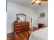 Comfortable main bedroom boasts natural light, a large dresser and hardwood floors at 718 E Washington St, Lebanon, IN 46052