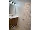 Bathroom with a white vanity and wooden cabinet, complemented by a well-lit mirror and fixtures at 7529 N Green Meadows, Fairland, IN 46126