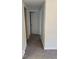 A hallway with neutral carpet leading to white doors offering a seamless transition between rooms at 7529 N Green Meadows, Fairland, IN 46126