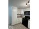 Charming kitchen features white cabinetry, stainless appliances, and ample counter space at 7529 N Green Meadows, Fairland, IN 46126