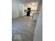 Bright kitchen boasts white cabinets, modern appliances, and stylish gray tile floors at 7529 N Green Meadows, Fairland, IN 46126