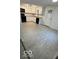 Bright kitchen boasts white cabinets, modern appliances, and stylish gray tile floors at 7529 N Green Meadows, Fairland, IN 46126