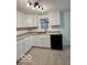 Well-lit kitchen featuring white cabinets, modern fixtures, and sleek black appliances at 7529 N Green Meadows, Fairland, IN 46126