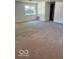 The living room has neutral walls, updated trim, a large window and carpet flooring at 7529 N Green Meadows, Fairland, IN 46126
