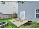 Backyard featuring a concrete patio, fire pit, and vinyl siding at 8212 Twin River Dr, Indianapolis, IN 46239
