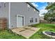 Backyard featuring a concrete patio, fire pit, and vinyl siding at 8212 Twin River Dr, Indianapolis, IN 46239